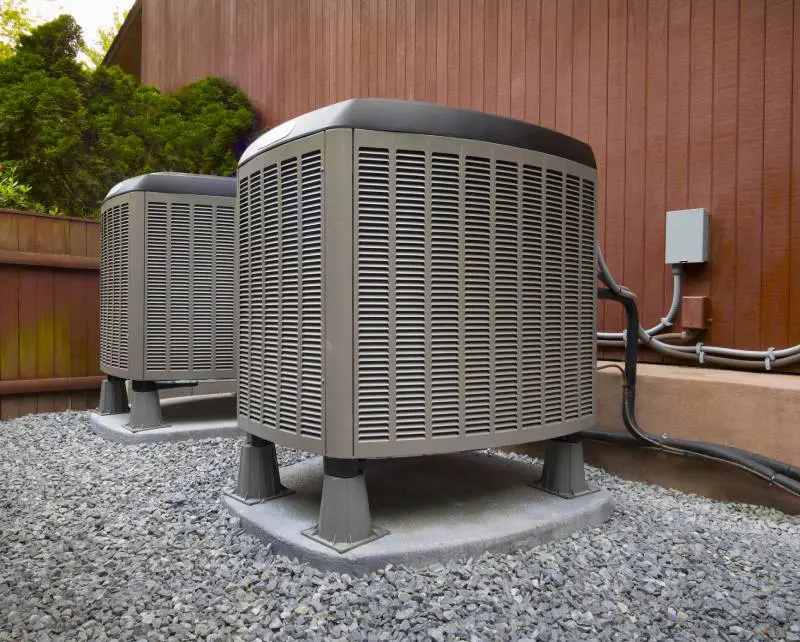 Two heat pump units outside a home