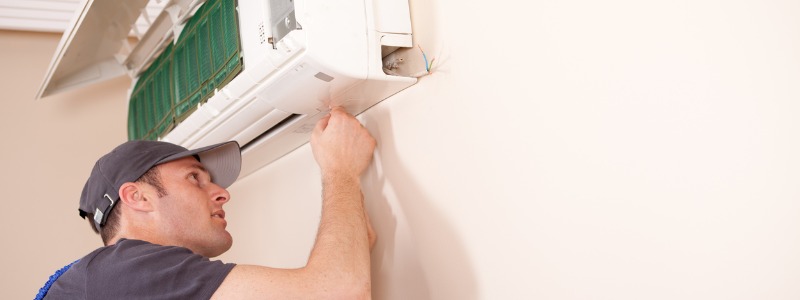 HVAC technician installing a ductless HVAC unit