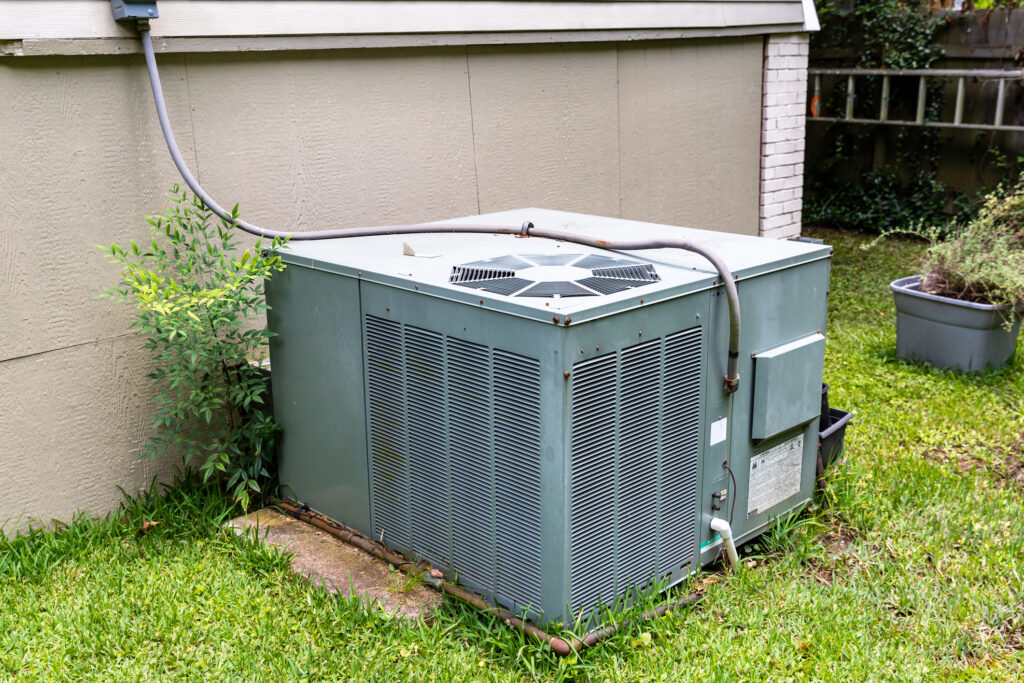 Package air conditioner system next to a home.