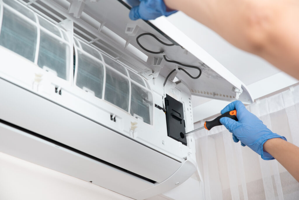 A technician servicing a ductless mini-split