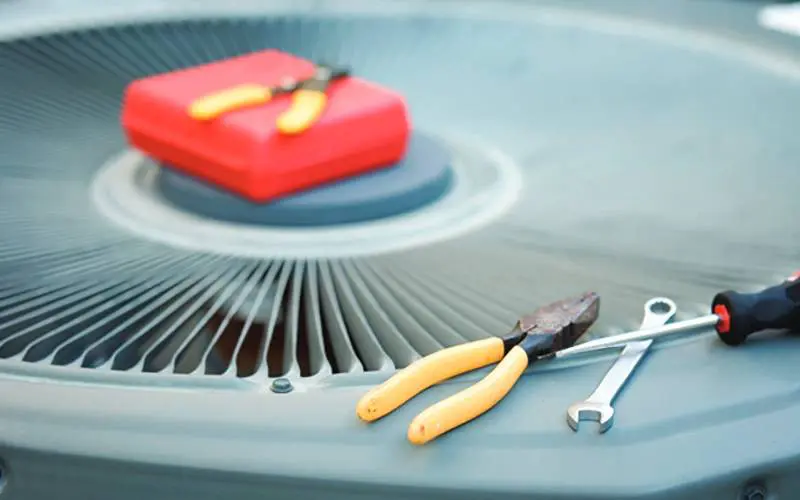 Tools on top of an HVAC unit