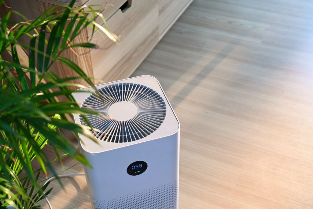 Air purifier on wooden floor in comfortable home. 