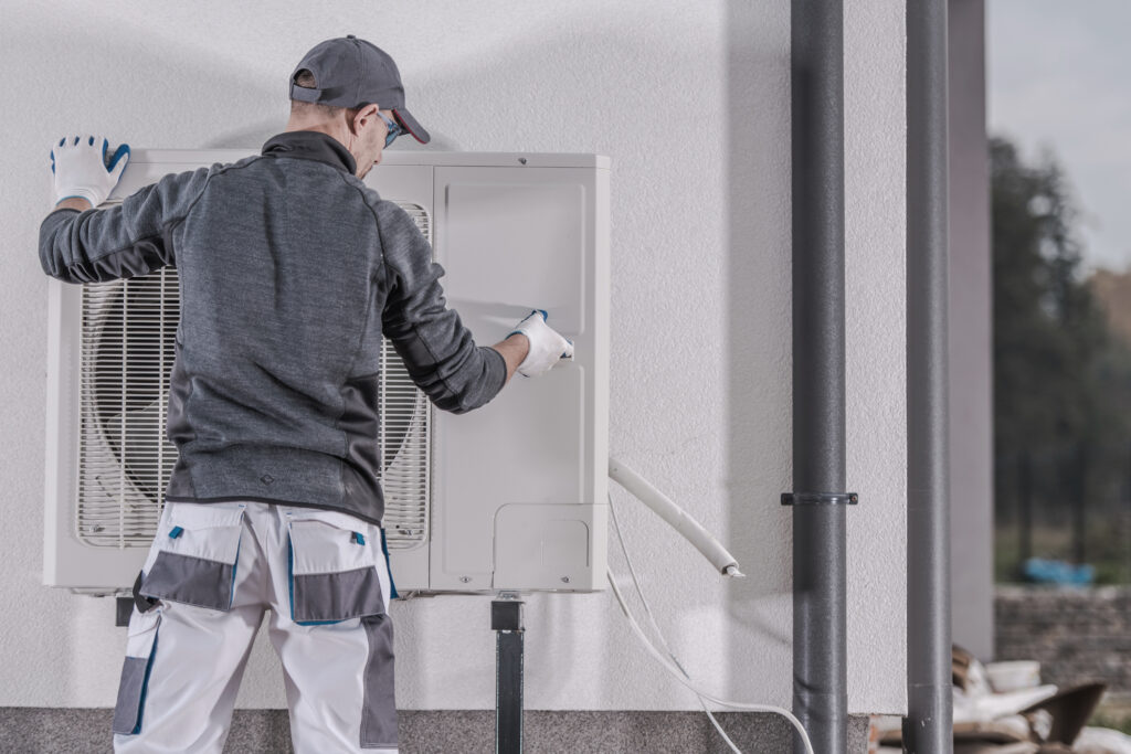 Technician repairing a heat pump.