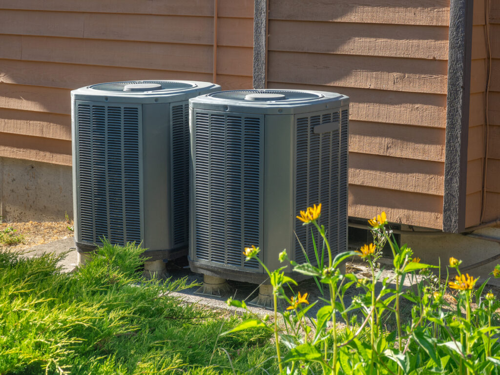 High-efficiency modern HVAC units outside an apartment complex