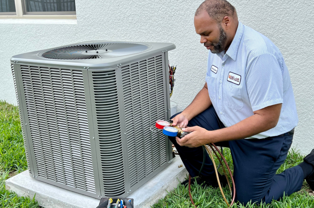 Del-Air HVAC technician with a new air conditioning unit