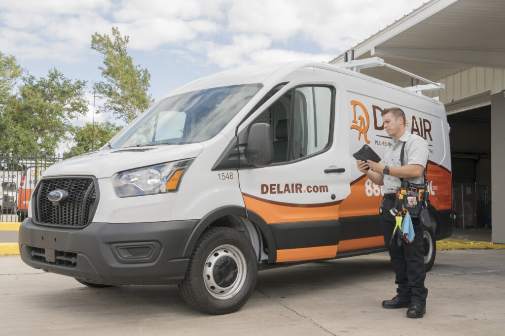 A Del-Air technician outside a service van